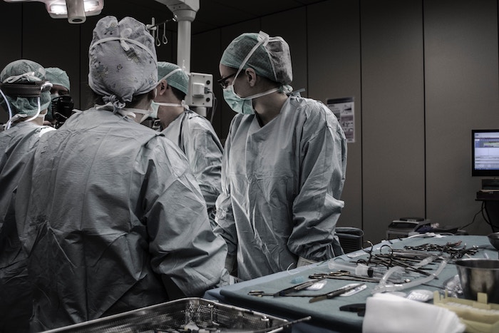 Doctors gathering around a surgery table